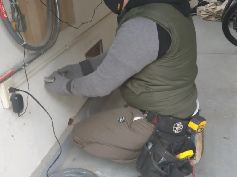 Electrician performing outlet wiring in a North Middleton garage